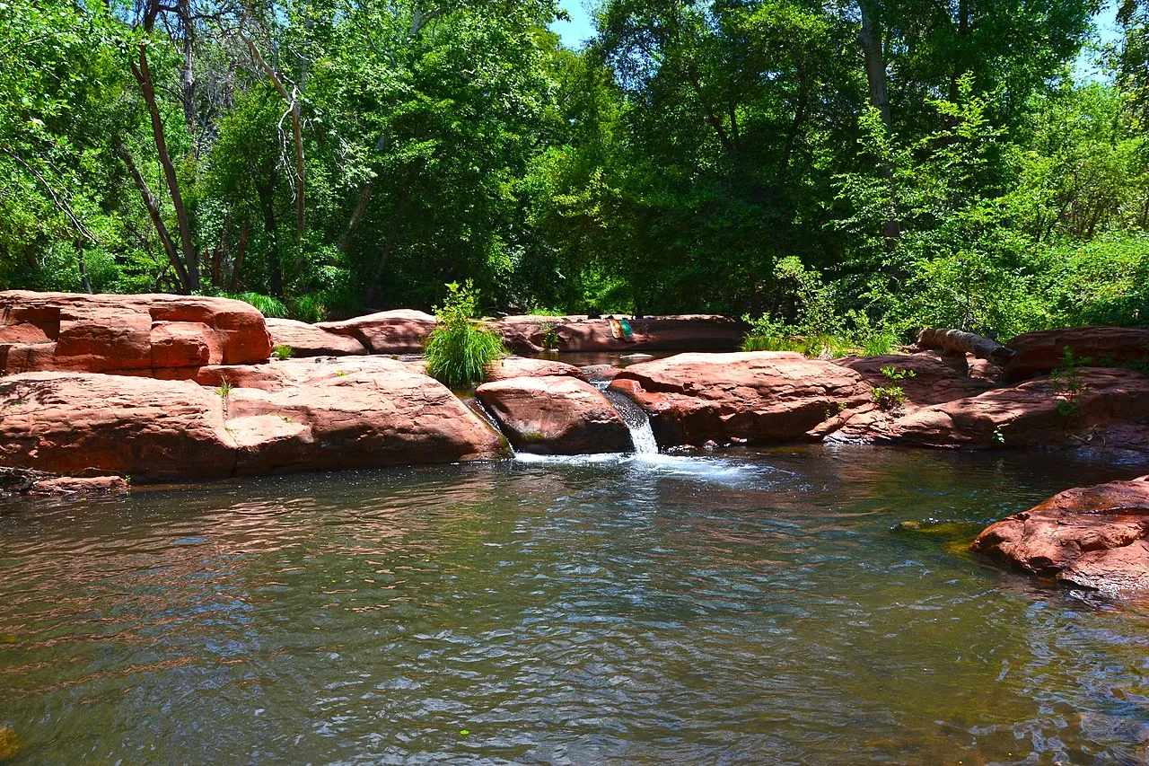 A deep creek pool framed by red-rock walls along Wet Beaver Creek