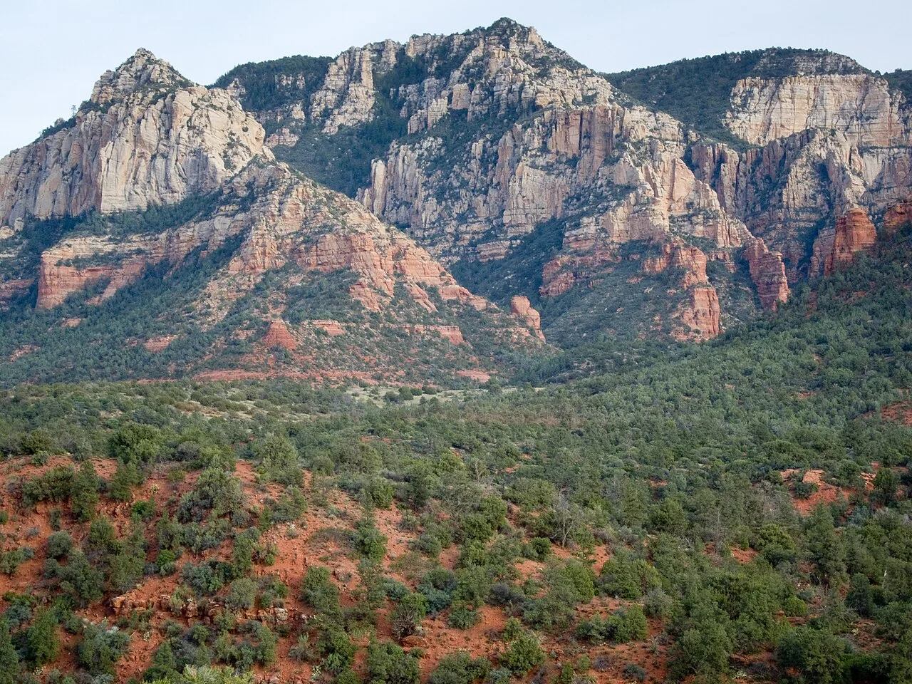 Uptown Sedona shopping strip along SR 89A with red rock formations behind