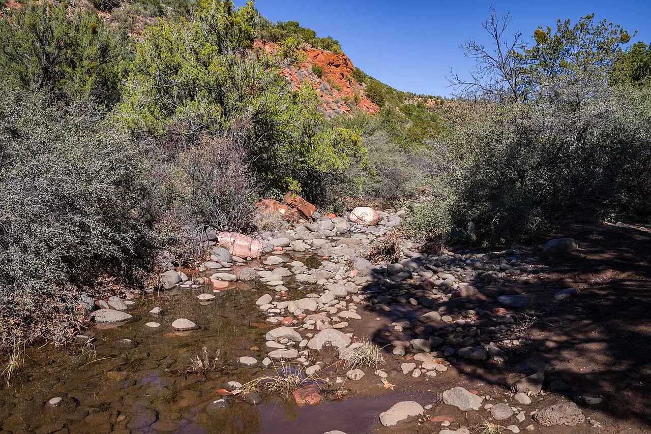 Open red-rock desert scenery on the approach to Devil's Bridge near Dry Creek, Sedona