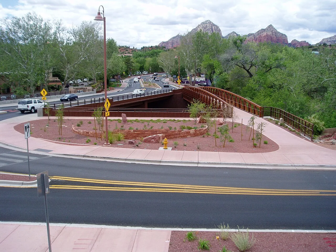 A roundabout on a Sedona highway with red rock buttes in the background