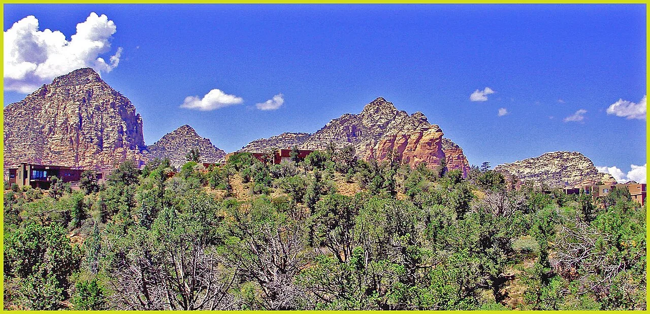 Uptown Sedona street scene with red rock cliffs rising behind the shops and restaurants