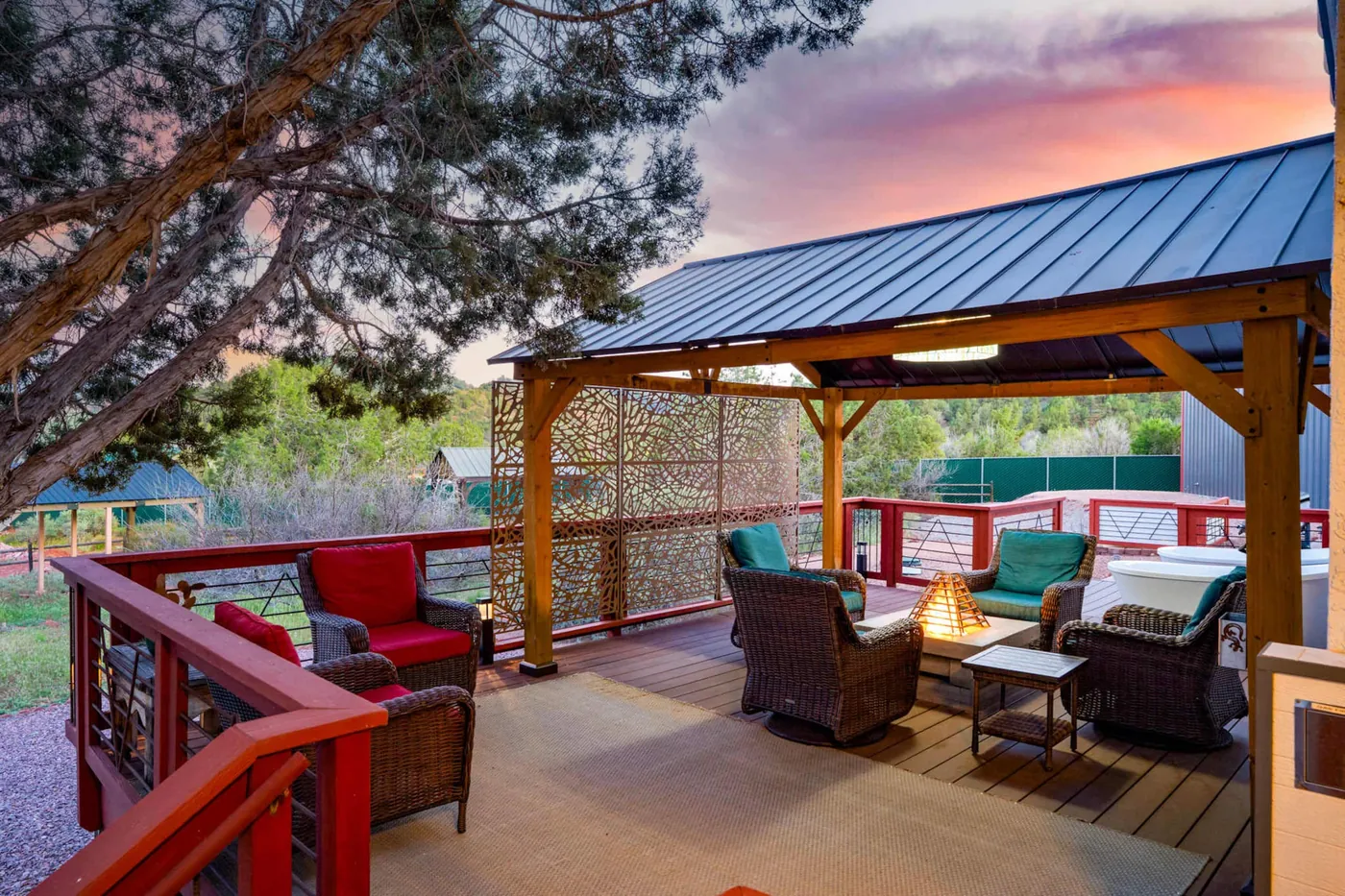 The home's covered deck and fire pit at dusk