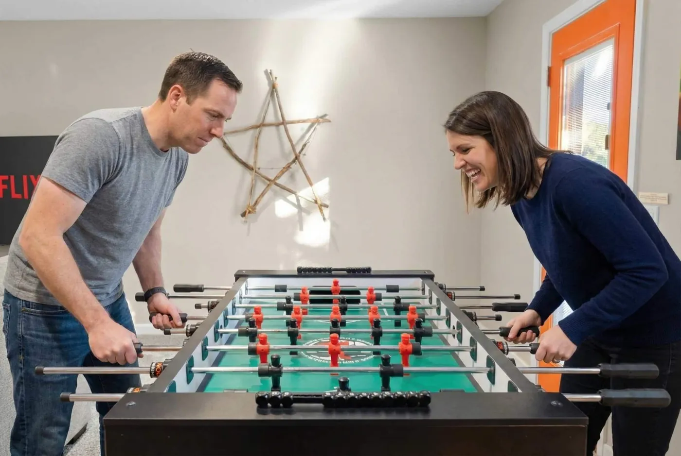 Guests playing foosball in the game room