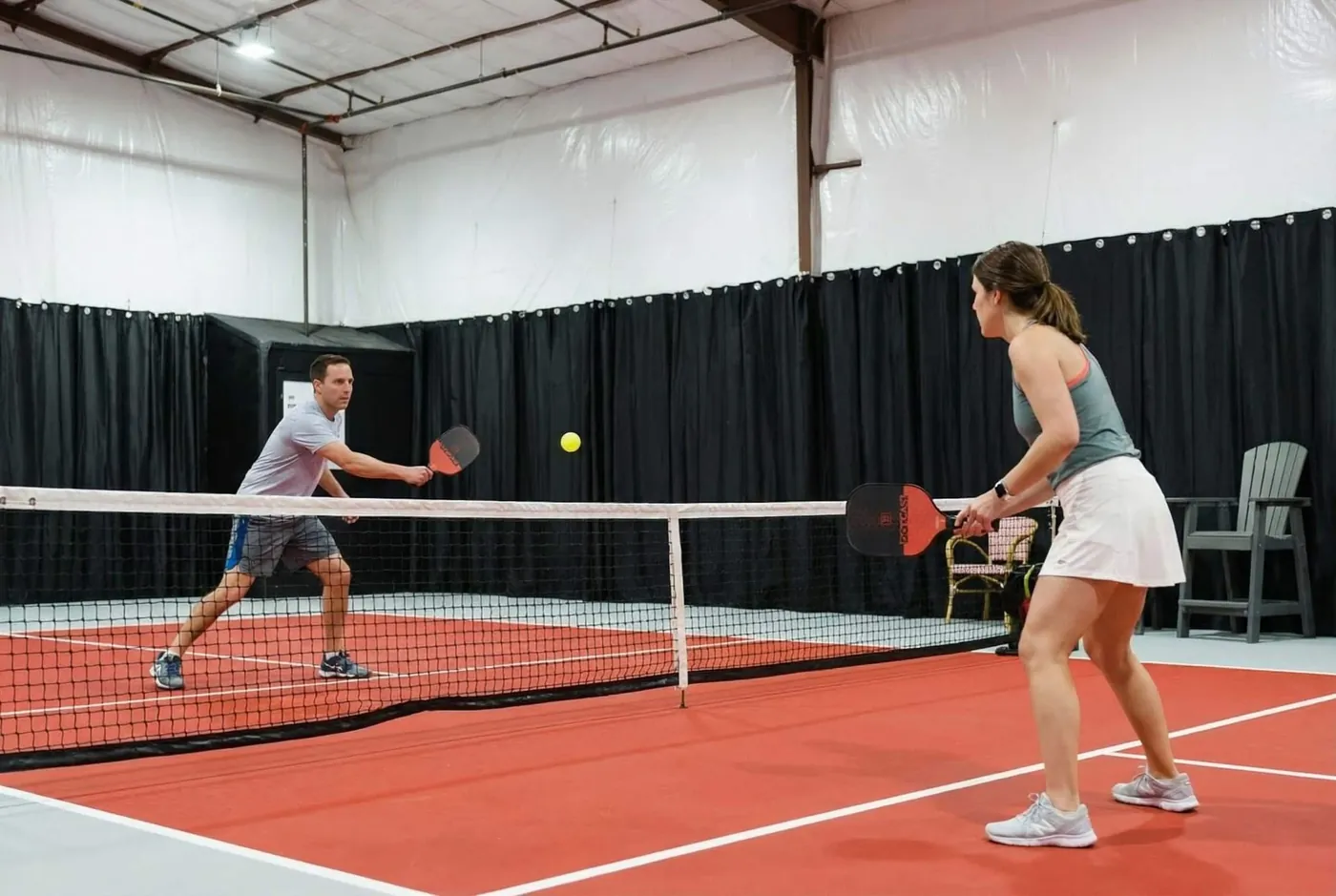 Two guests playing on the private indoor pickleball court at Sedona Pickler
