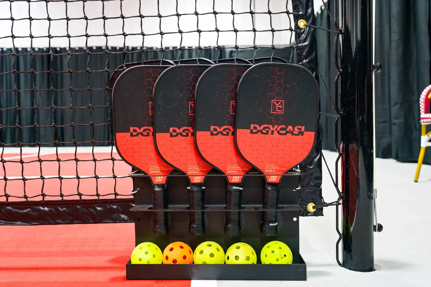 Pickleballs lined up courtside ready for play