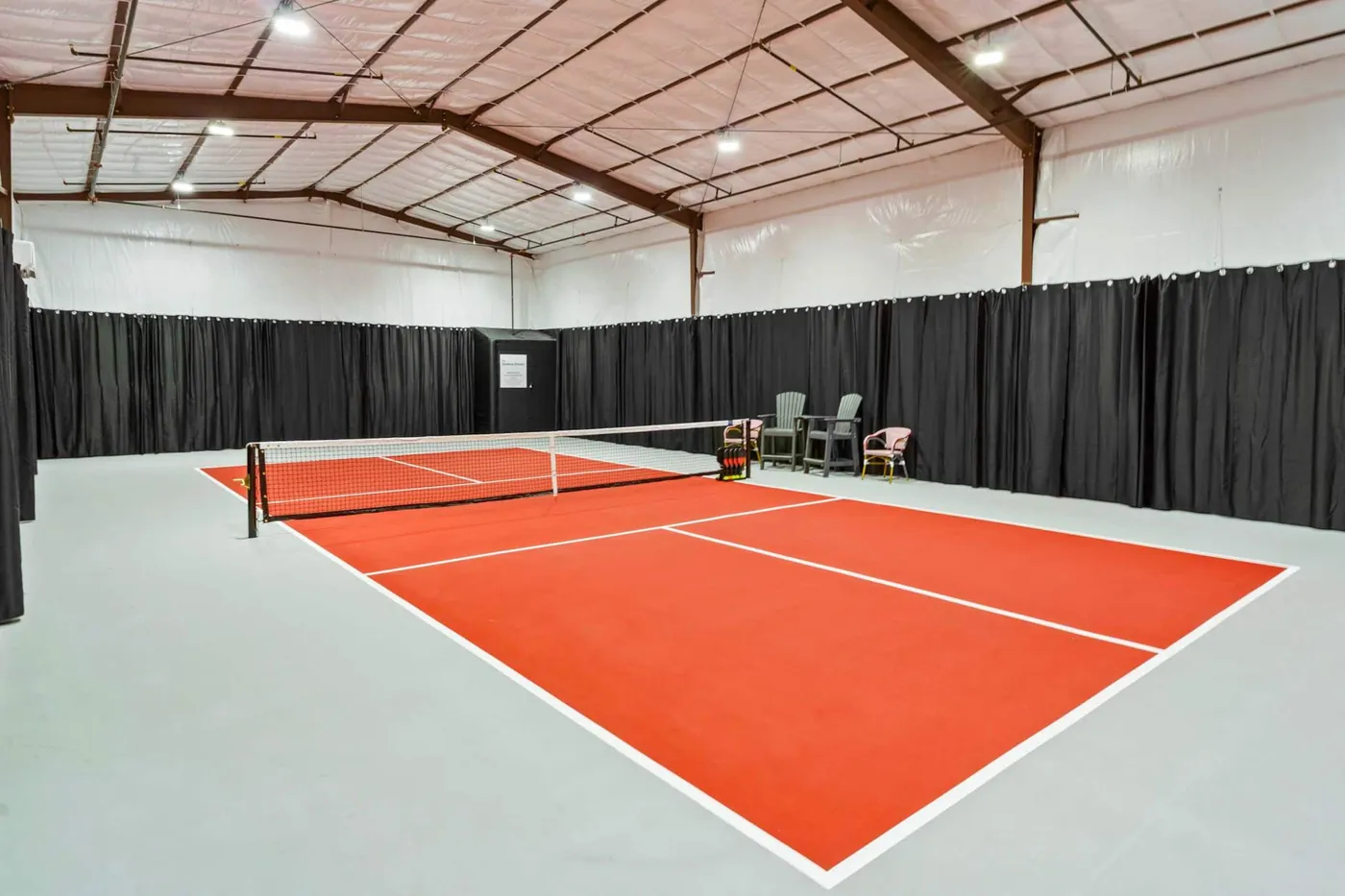 The cushioned floor of the indoor pickleball court