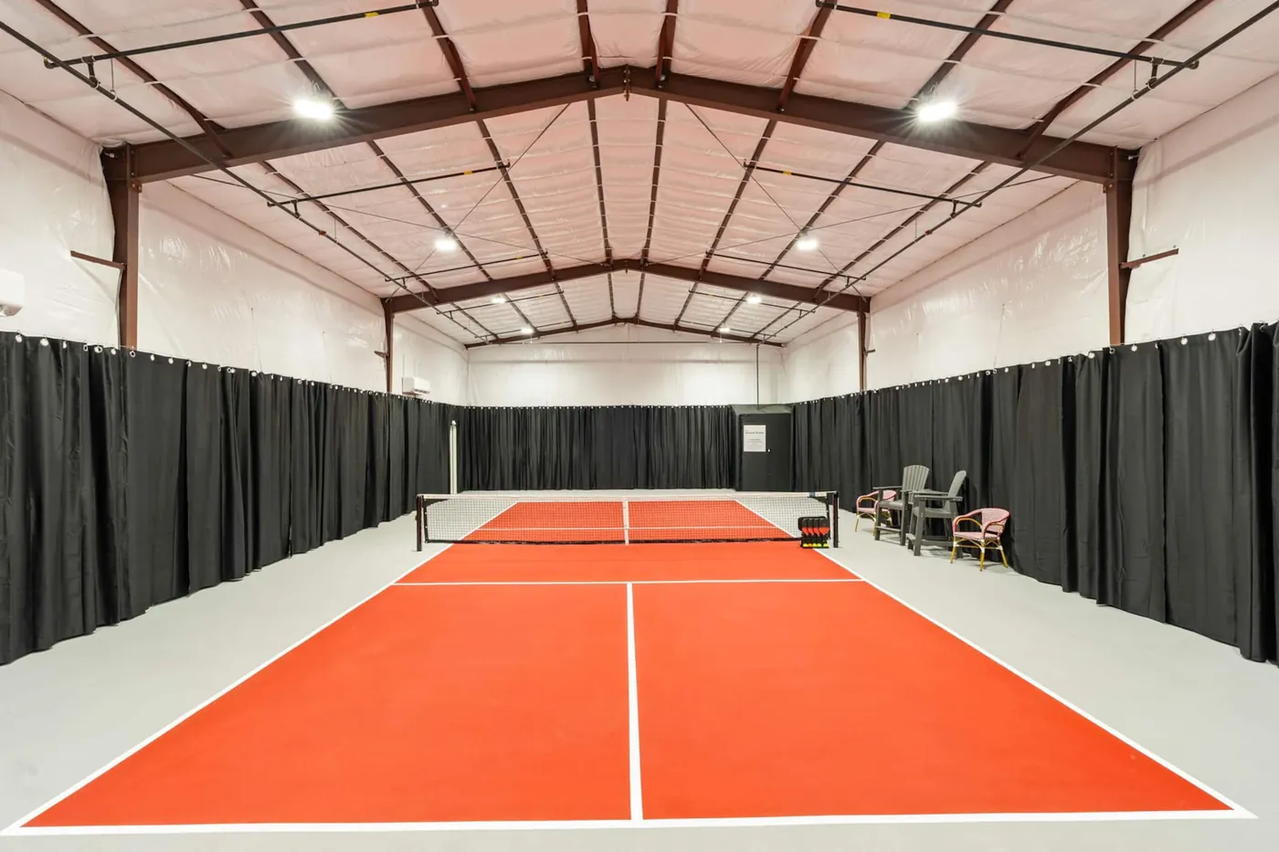 Looking across the private indoor pickleball court and net