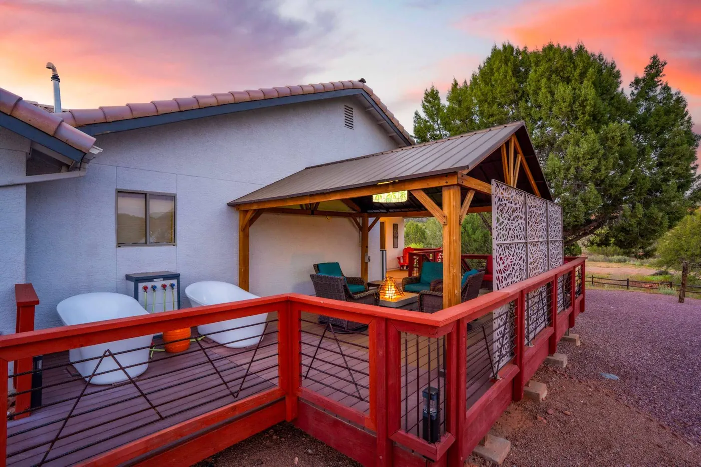 The back deck with its soaking tubs and pergola at sunset